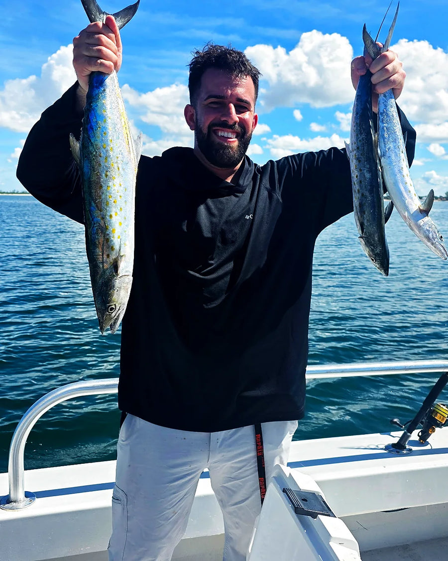 Male angler holding fish on a Sarasota fishing charter