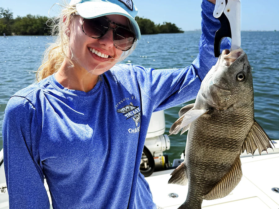 Female private charter guest smiling with her catch