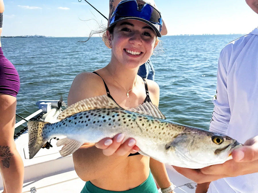Female angler holding a nearshore fishing catch