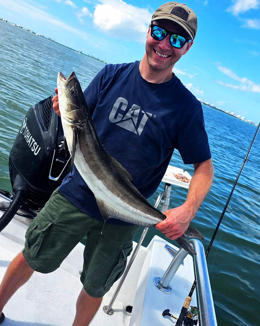 Male angler holding a big fish on a Sarasota sportfishing charter
