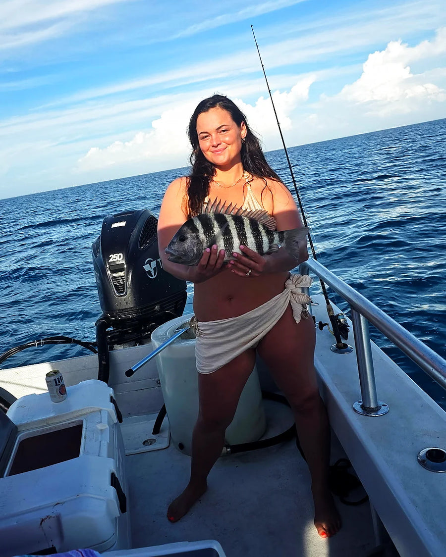 Female angler holding a catch on a Sarasota sportfishing trip